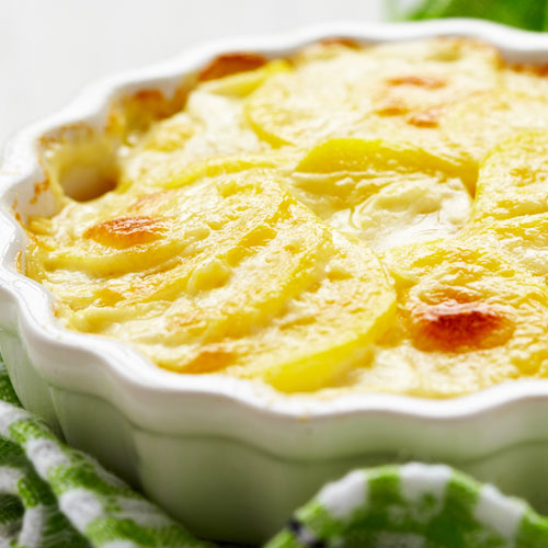 Scalloped potatoes in a white casserole dish