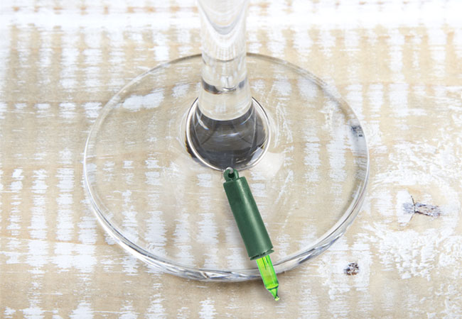 the base of a wine glass with a wine charm