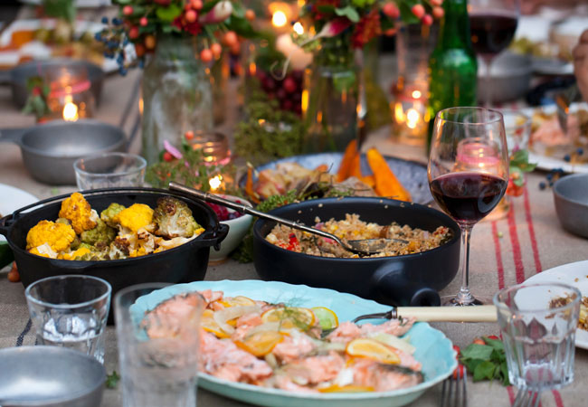 An outdoor candle-lit potluck dinner